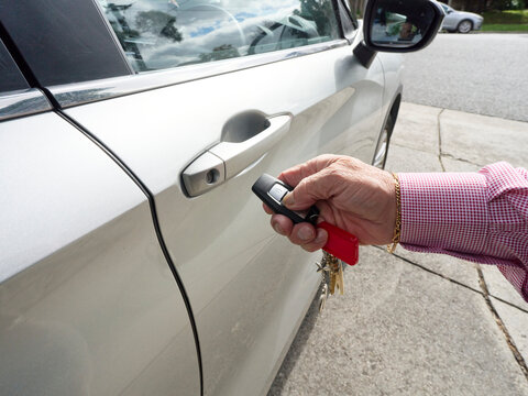 Person Using Key Fob to Unlock Car Door