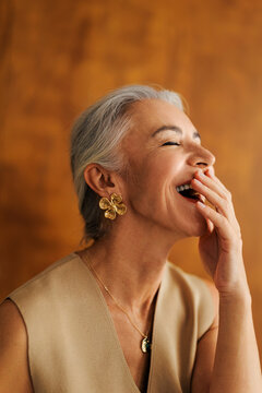 Senior woman laughing enjoying a funny moment feeling happy