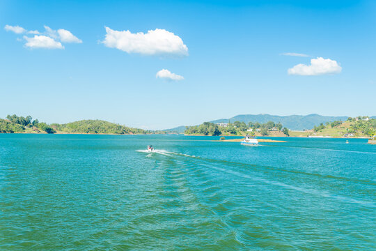 Guatape penol reservoir with speed boat and ferry