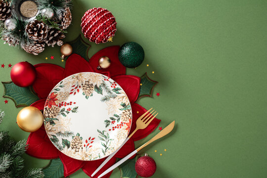 Christmas table setting with plate and baubles on green background
