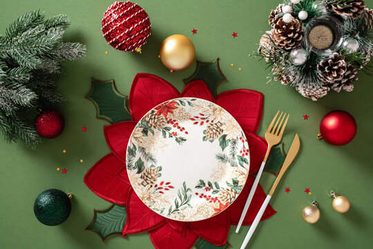 Christmas table setting with plate and red poinsettia placemat