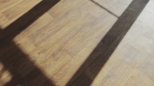 The gentle sunlight streaming through a window creates a dancing shadow on the cozy wooden floor, evoking a feeling of tranquility and the subtle passage of time