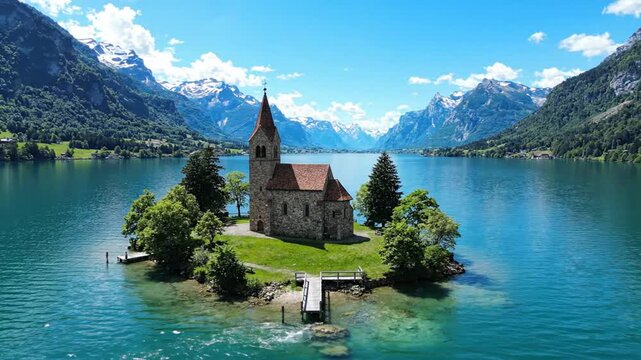 Stone church on island in turquoise alpine lake with mountains