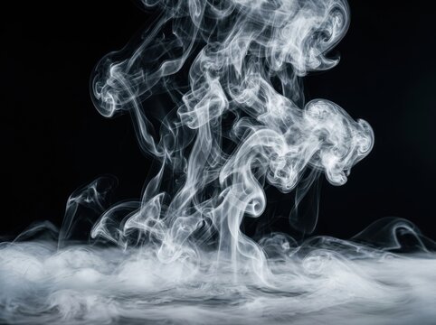 Intricate white smoke plumes and swirling wisps rising from a dense base against a solid black background