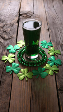 Coffee cup surrounded by green shamrocks on a rustic wooden table