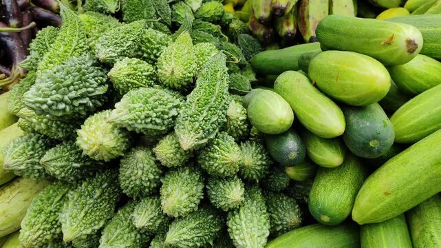 Fresh organic sponge gourd and bitter gourd displayed at market