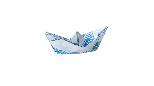 Origami paper boat made from blue and white patterned paper isolated transparent background
