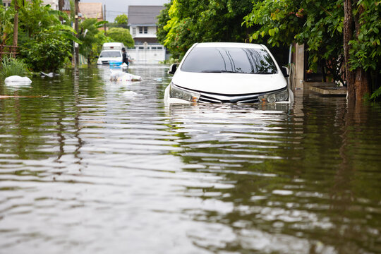 Cars submerged in water. Street after heavy rain. Disaster Motor Vehicle Insurance Claim, Severe weather