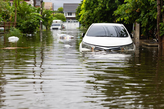 Cars submerged in water. Street after heavy rain. Disaster Motor Vehicle Insurance Claim, Severe weather