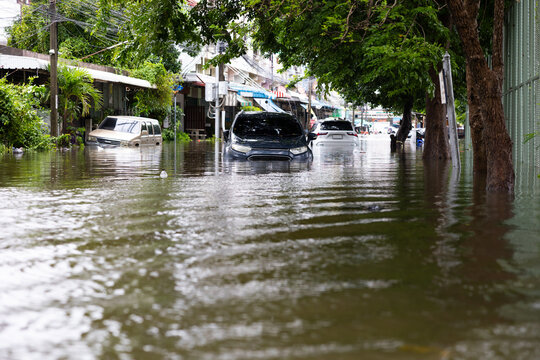 Cars submerged in water. Street after heavy rain. Disaster Motor Vehicle Insurance Claim, Severe weather