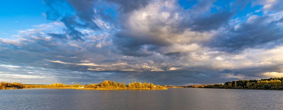 Vast lake stretches beneath a dramatic sky
