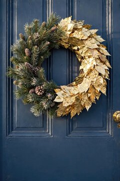 Elegant Gold and Pine Wreath Decoration on Blue Door