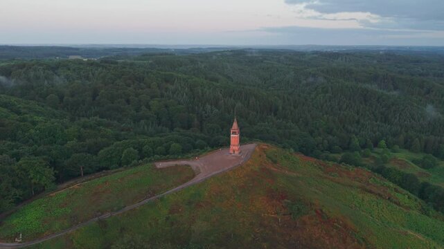 Aerial view of the historic Himmelbjerget tower situated on a forested hill in Skanderborg Municipality, Skanderborg Municipal, Denmark.