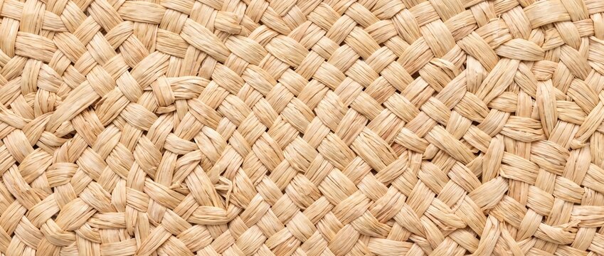 Natural raffia straw weave texture. Braided wicker basket background. Handcrafted summer hat material