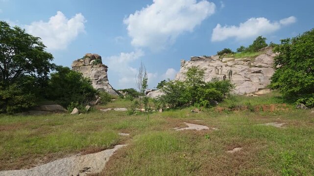 Rocky landscape with green trees and blue sky