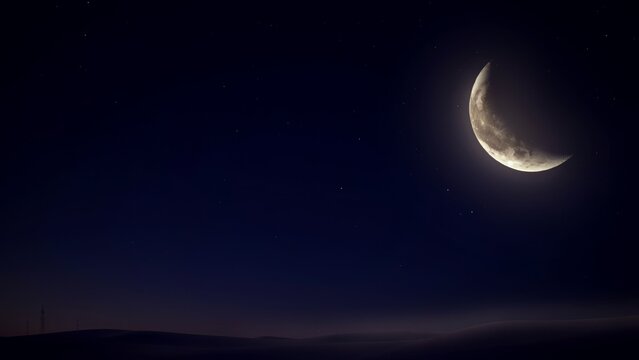 Crescent moon shining over a dark night landscape