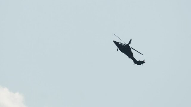 Military attack helicopter Eurocopter Tiger performing aerobatics