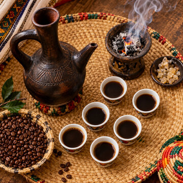 Traditional Ethiopian Coffee Ceremony with Jebena, Cini Cups, Roasted Beans, and Incense Burner