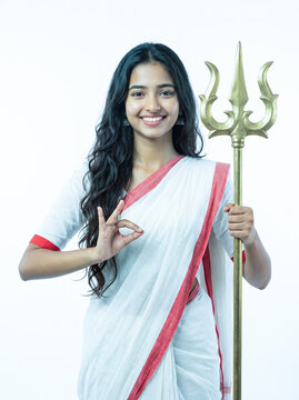 Young Bengali Woman in Traditional Saree Holding Trishul Trident as Goddess Durga