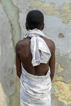 Boy wrapped in cloth seen from behind, Cape Coast, Ghana