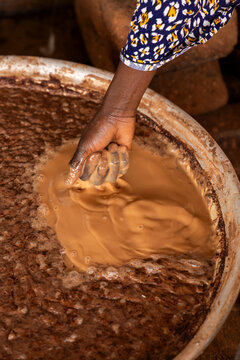 Hand kneading shea butter paste in a basin, Tamale, Ghana