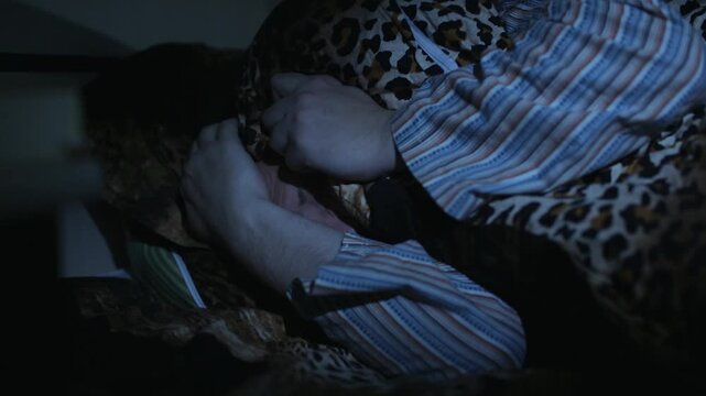 Terrified Man Hiding Under Blanket in Bed Having Nightmare or Insomnia
