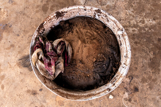 Basin of shea butter residue with cloth, Tamale, Ghana