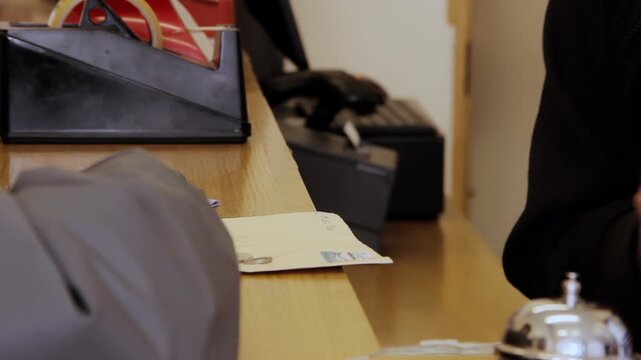 Close Up of Customer Paying with Coins at Post Office Counter Desk - 4K