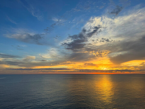 Golden sunset over calm sea waters