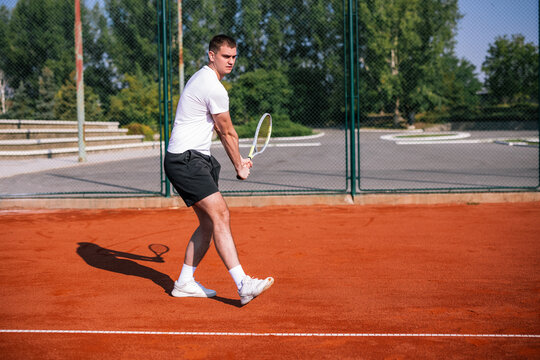 Side view of tennis player preparing two handed backhand stroke on court