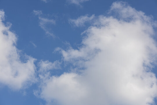 White clouds in blue sky with large copy space in daylight