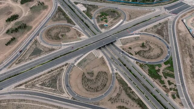 Aerial View of Highway Cloverleaf Interchange with Light Traffic and Landscaped Ramps