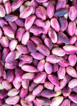 Fresh raw pistachio nuts in shell natural background. Fresh pistachios for sale at a street market. Turkish known as "Fistik or Antepfistigi"