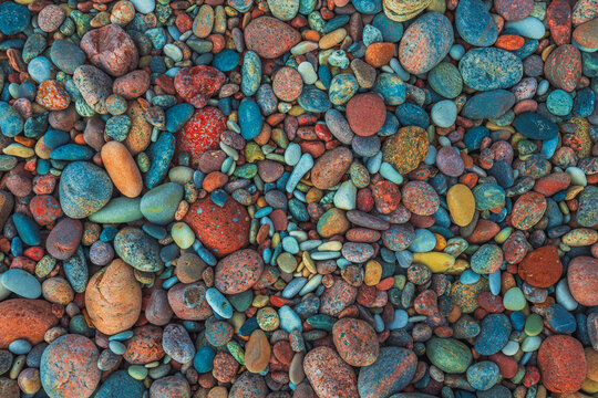 A close-up image of various smooth colorful rocks