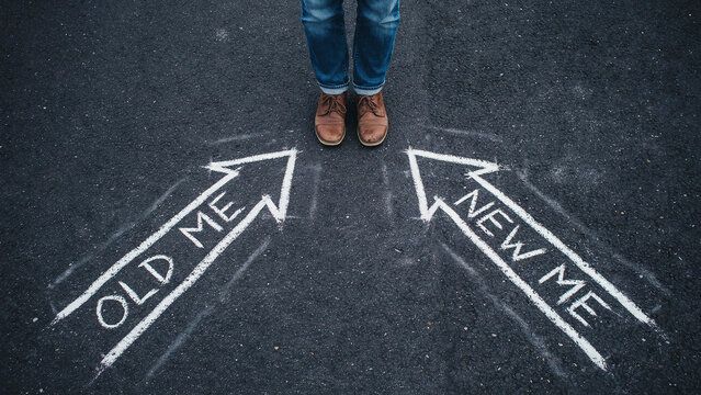 Concept of decision making with old and new me written on asphalt