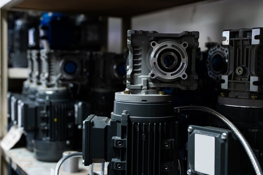 Industrial electric motors and gearboxes on warehouse shelves