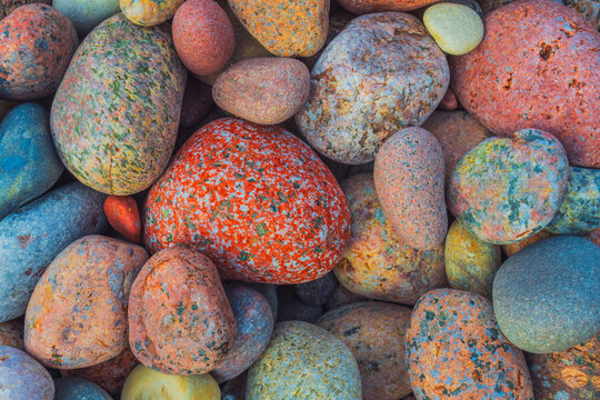 A close-up image of various smooth colorful rocks