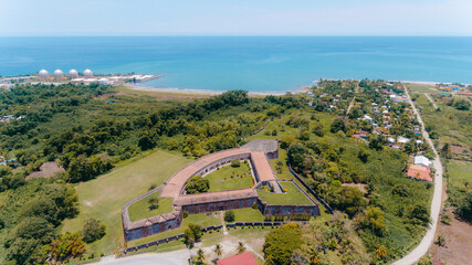Aerial drone view of the historic San Fernando de Omoa Fortress surrounded by tropical vegetation on the Caribbean coast of Omoa, Honduras, Central America.. © Erick