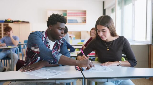 Male student cheating by copying female student's exam