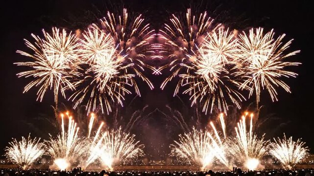 Colorful fireworks display exploding in night sky over crowd celebrating new year, festival, and celebration