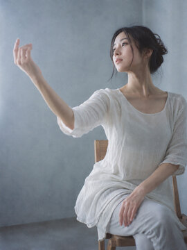 Seated Dancer Raising an Arm by a Window