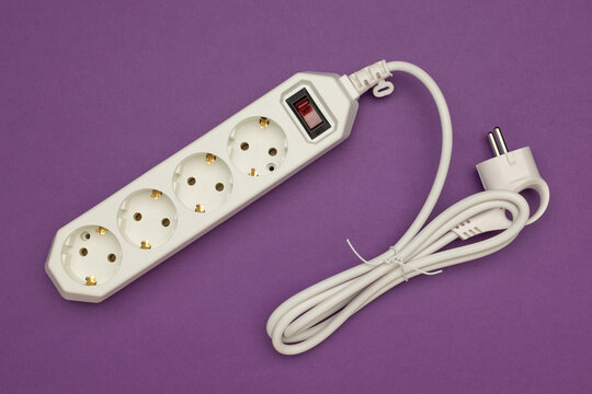 White Power Strip with Four Outlets and Switch on Purple Background