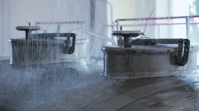 Stainless steel milk tanks water spray washing. Dairy plant equipment cleaning.