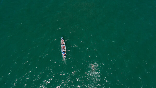 Aerial view of the Gulf of Fonseca showing calm blue waters, a small boat, a swimmer. Honduras.