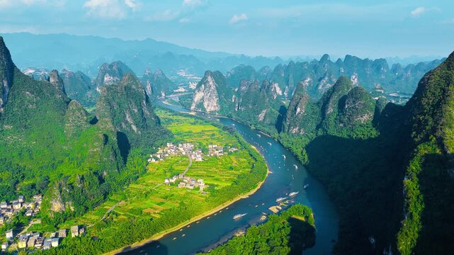 High angle view reveals iconic karst mountain peaks along the winding Li River near Xianggong Mountain in Guilin.