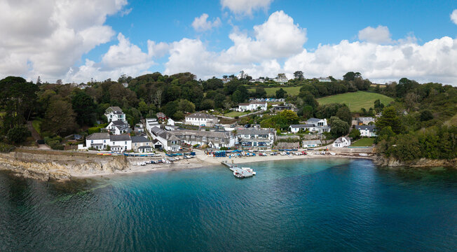 Aerial panorama of Helford Passage in Cornwall, UK with holiday cottages and ferry boat jetty