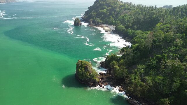 Aerial drone footage of Wedi Awu Banyu Anjlok beach coastline with turquoise water in Malang East Java