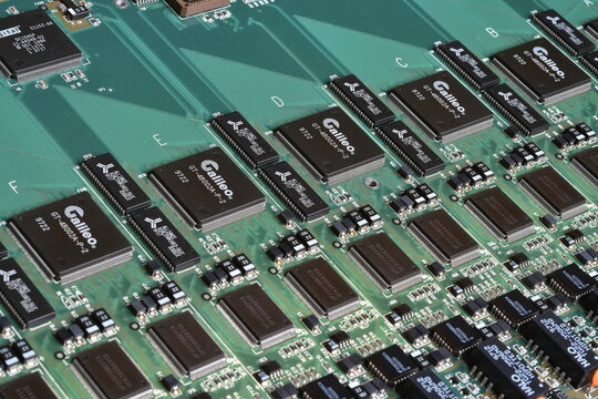 Florence, Italy - 16th February 2026: Vintage green circuit board macro view with semiconductor microchips, processors and computer engineering hardware components