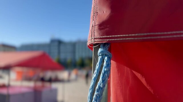 Red Helsinki Hakaniemi Market Stall Canopy and Rope Against a Blue Sky