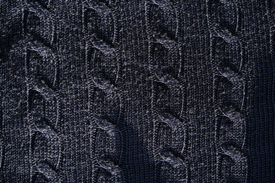 dark navy blue wool cable knit fabric with braided pattern, soft warm sweater texture.